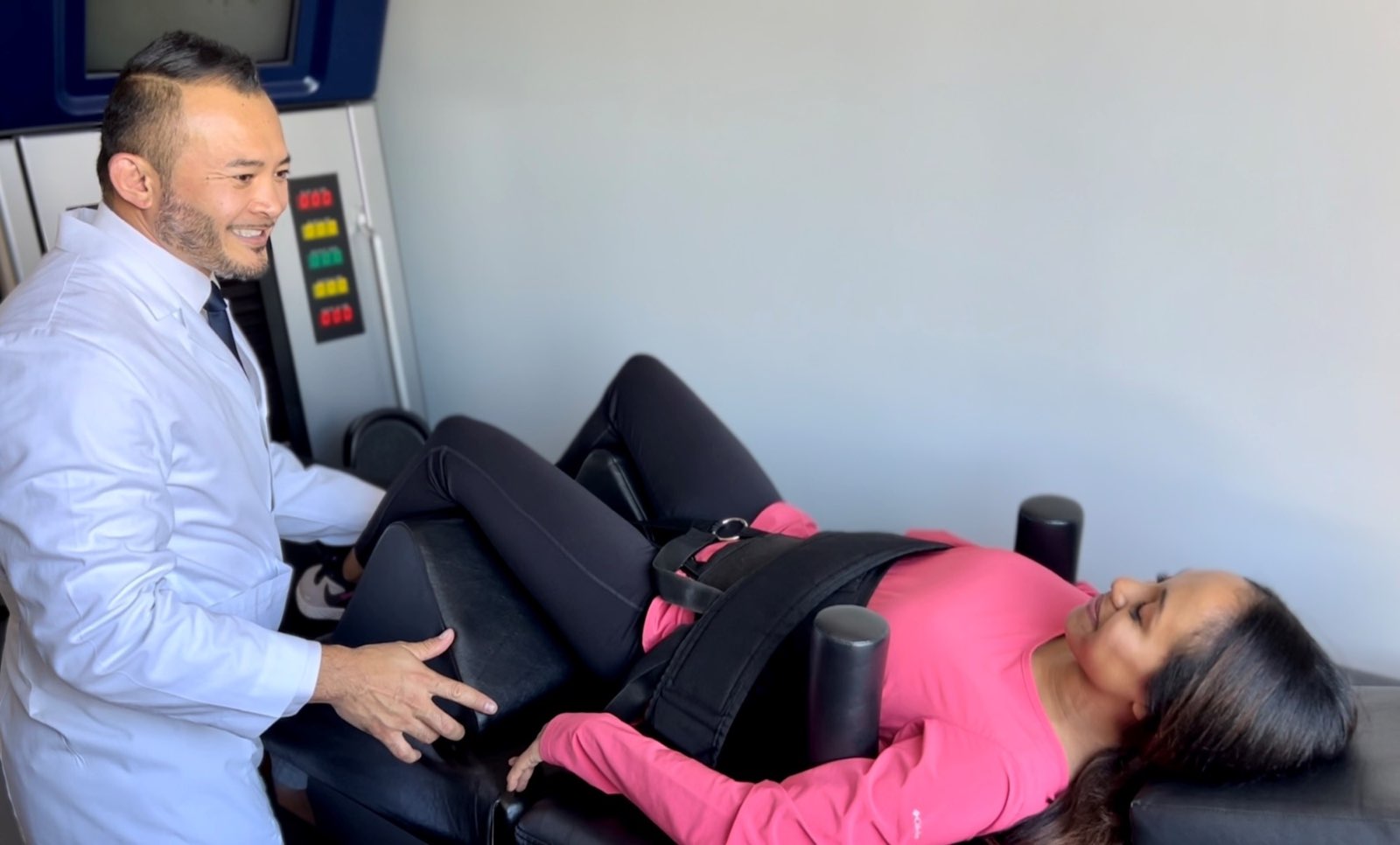 Dr. Peter Le positioning a patient comfortably on the DRX9000 decompression table