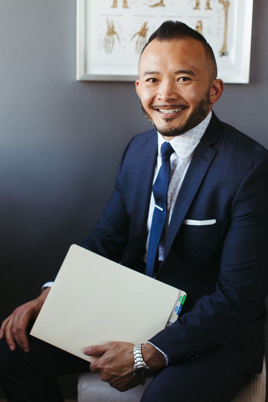 Dr. Peter Le holding a patient file