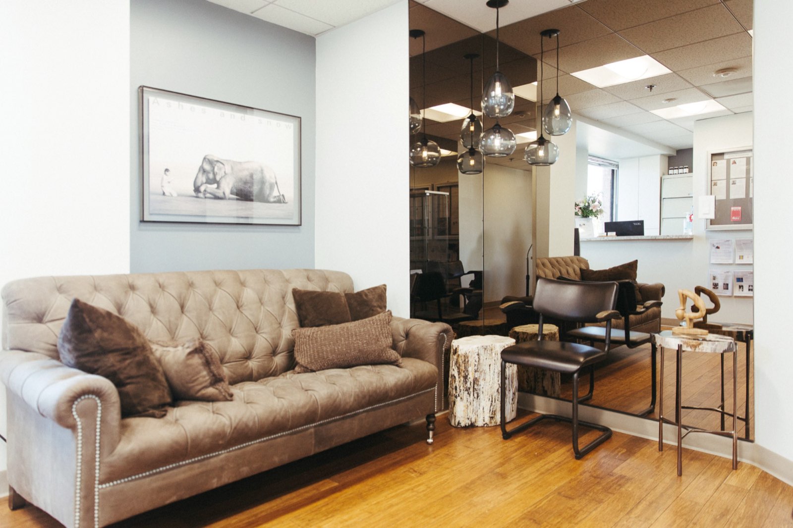 Reception lounge with tufted sofa and pendant lights
