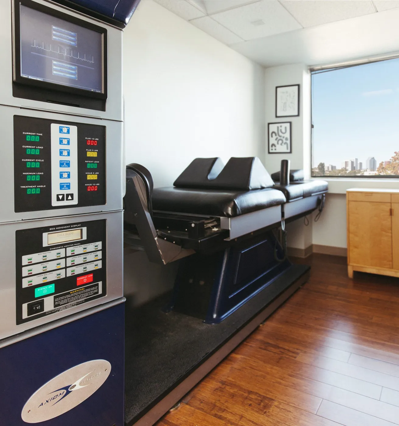 DRX9000 spinal decompression table in a bright treatment room overlooking Santa Monica